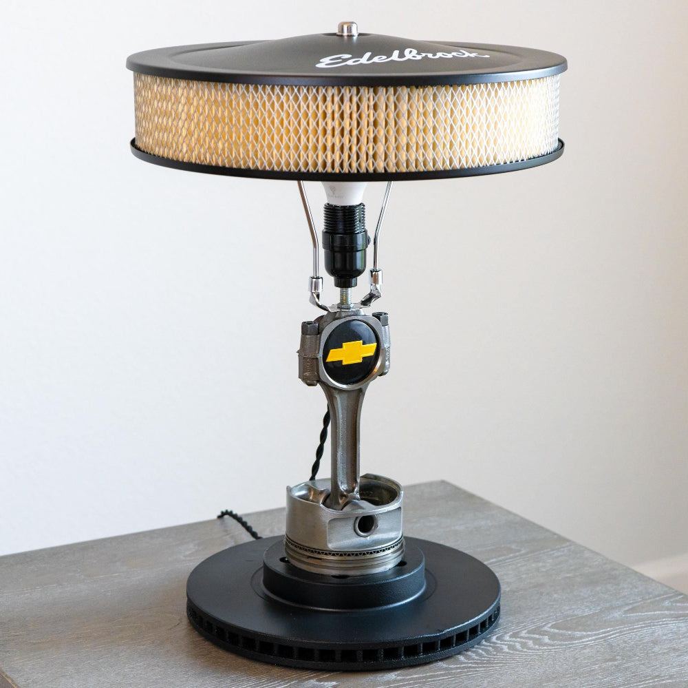 350 Chevy piston lamp featuring a clear coated piston and matte black rotor base for bold automotive style.