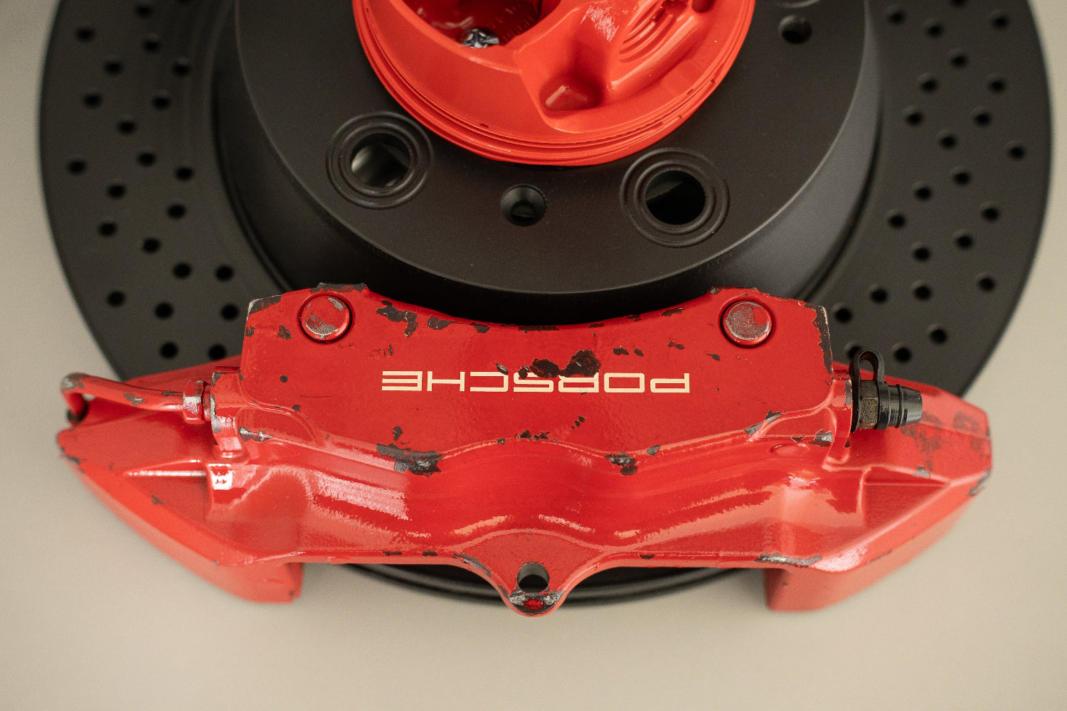 3G Unique Decor custom automotive lamp made from a red Porsche brake caliper and drilled brake rotor.
