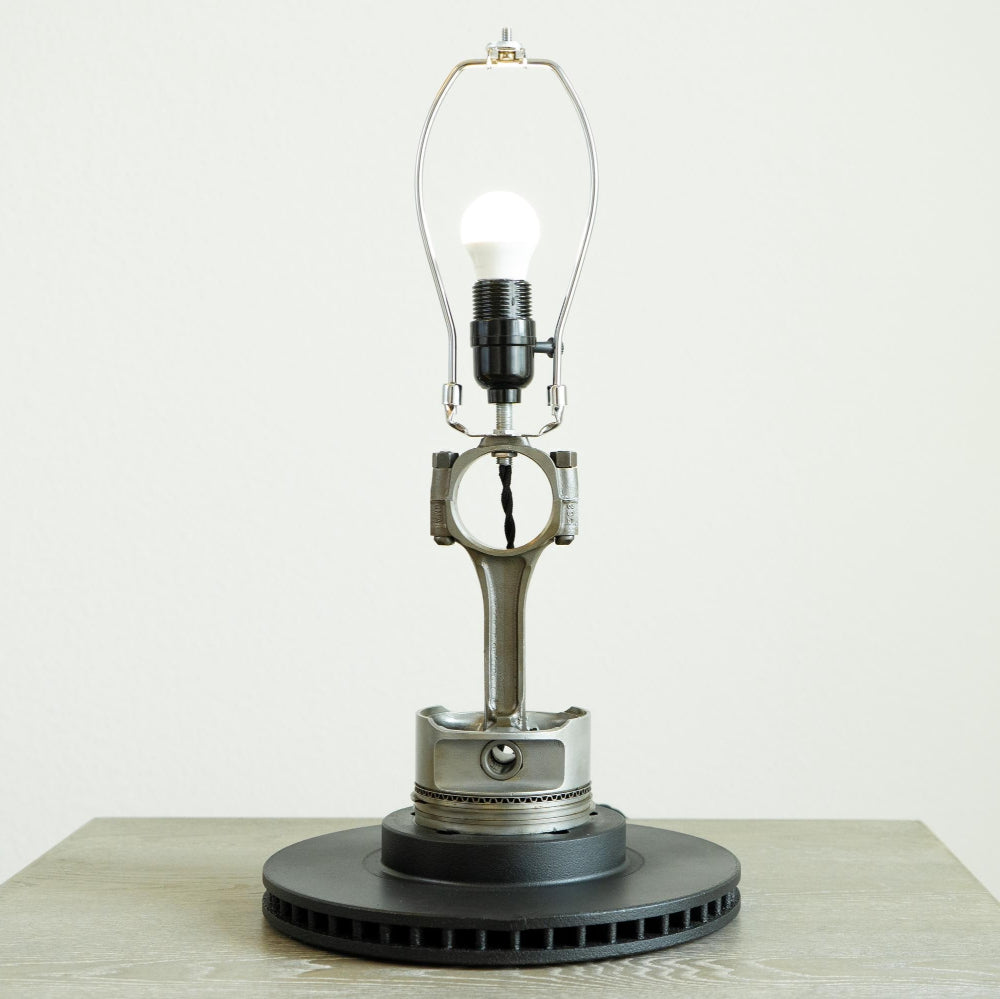 Table lamp made from mechanical parts on a white background