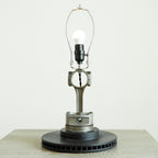 Table lamp made from mechanical parts on a white background