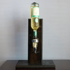 Bottle of white wine on a wooden stand against a gray background
