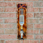 Decorative glass object with tortoiseshell pattern on a brick wall