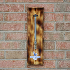 Wooden bottle opener with Grey Goose branding on a brick wall
