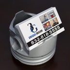 Business card with '3G Unique Decor' on a metallic object against a dark background