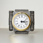 Decorative clock with metallic frame and white face on a light background