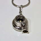 Metallic turbocharger keychain on a white background
