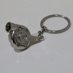 Metallic turbocharger keychain on a white background