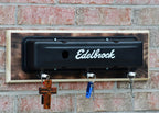 Edelbrock oil pan wall mount with hooks on a brick wall