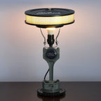 Industrial car parts lamp crafted from a real piston and gear, offering bold automotive style and functional lighting.