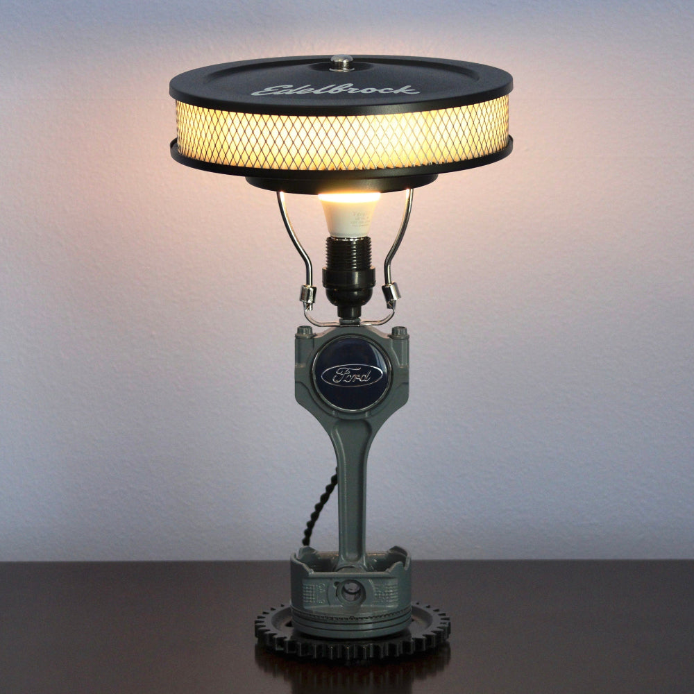 Industrial car parts lamp crafted from a real piston and gear, offering bold automotive style and functional lighting.
