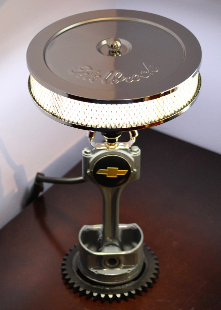 automotive piston lamp crafted from real car parts, blending mechanical detail with functional automotive lighting.