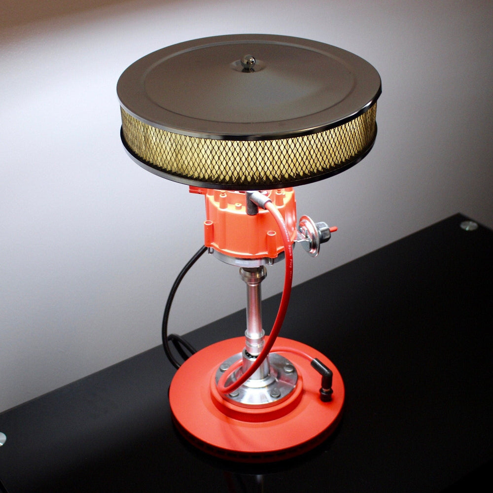 Automotive distributor lamp built from real car parts, combining a distributor body, air filter shade, and rotor base.