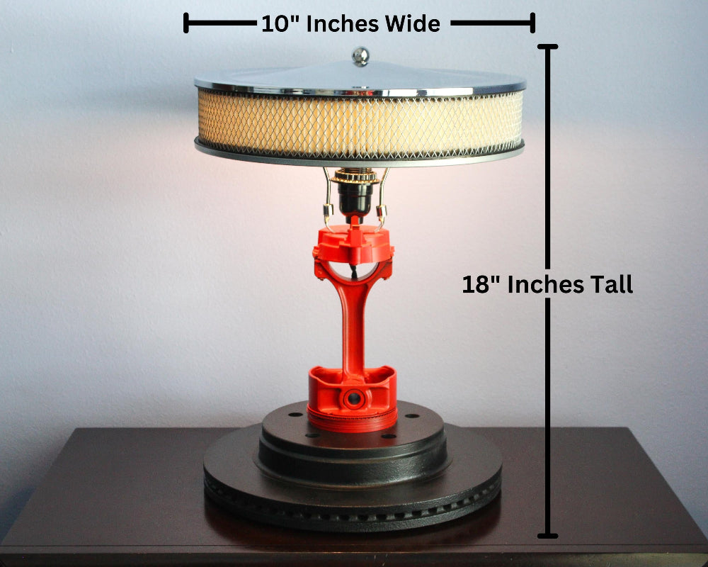 Piston lamp made from real car parts, designed with industrial metal components and functional lighting for automotive-inspired spaces.
