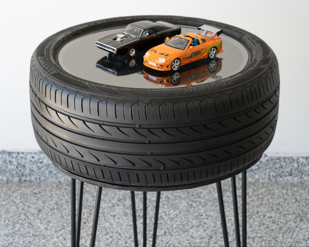 Automotive bar height tire table made from a real tire, built for man caves, garages, and car-themed spaces.
