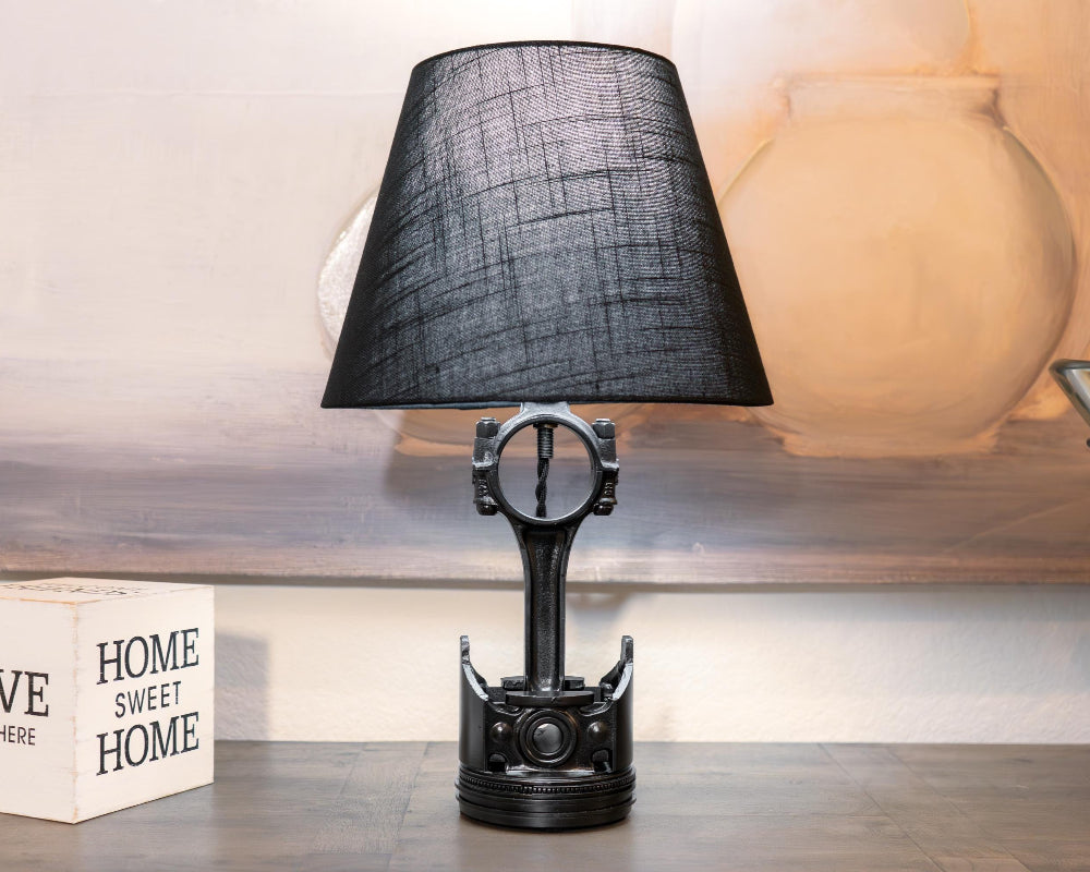 Car parts piston lamp made from a real upcycled piston, offering functional lighting with understated automotive decor appeal.