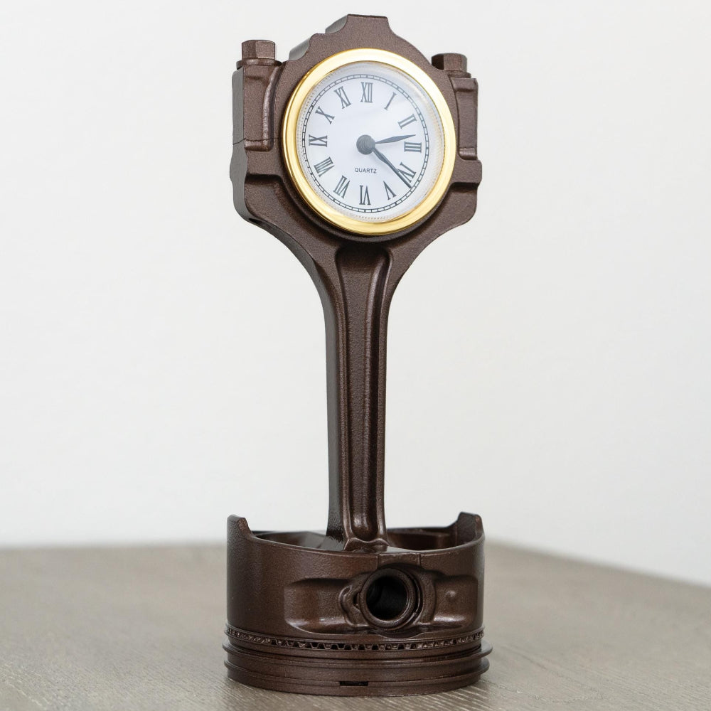 Clear coated Ford piston clock preserving raw metal character.
