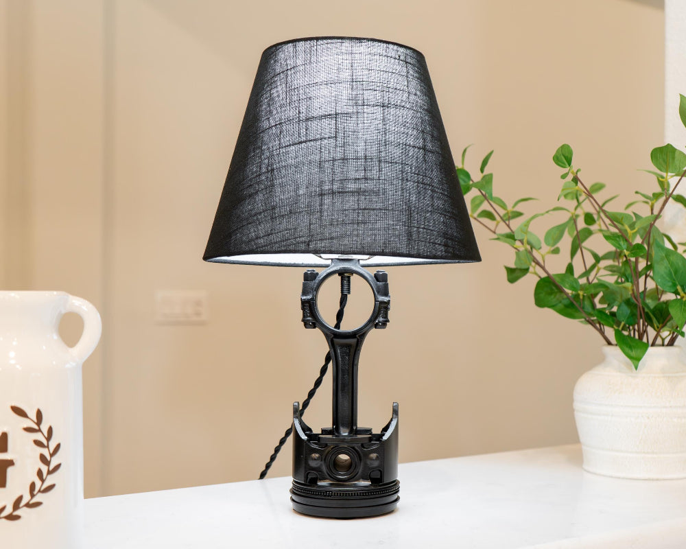 Desk-sized piston lamp designed from real car parts, providing subtle automotive decor suitable for home or office use.