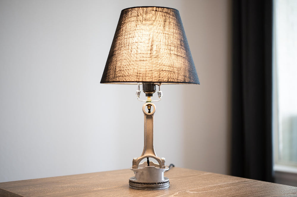 Desk sized piston table lamp designed to fit naturally on nightstands, shelves, and workspaces.