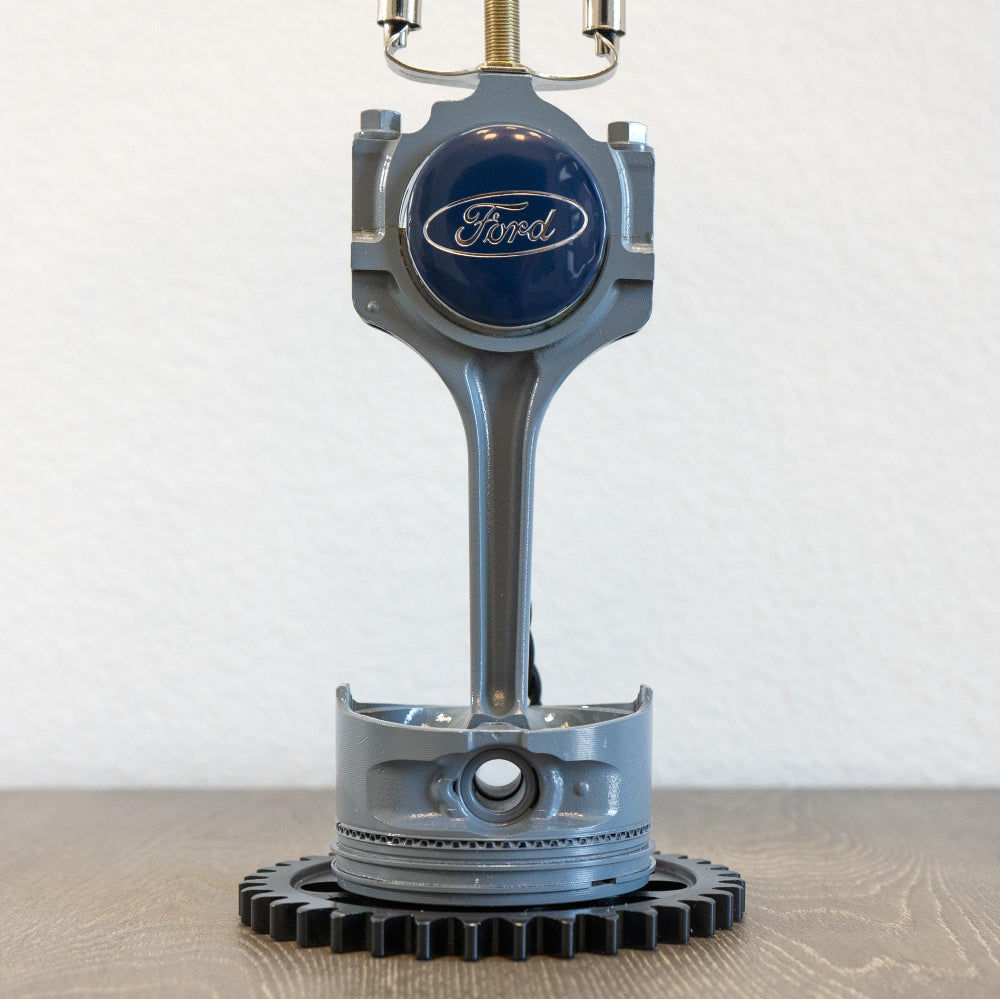 Ford piston lamp sized for desks or nightstands, made from genuine engine parts and styled for everyday interior use.