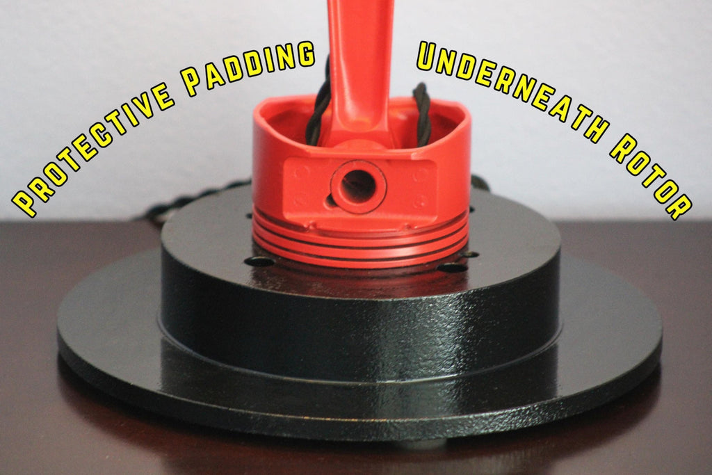 Car parts lamp made from real automotive components, built for garages and man caves with durable metal lighting design.