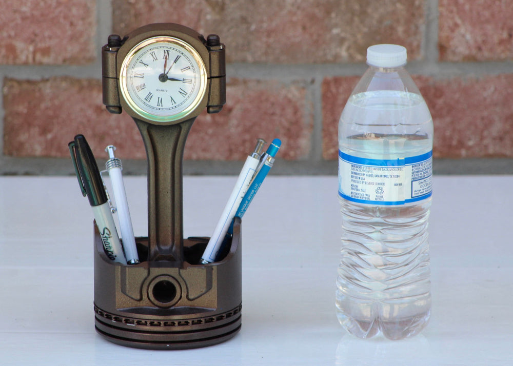 Garage desk piston clock combining mechanical style with everyday practicality and organized storage.