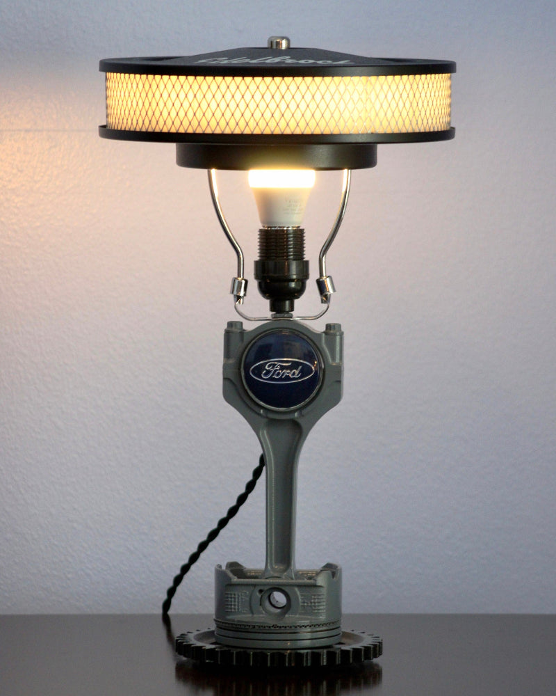 Ford piston lamp designed for garage decor, handcrafted from real automotive components with durable metal construction.
