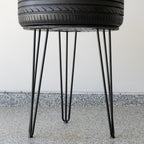 Handcrafted bar height tire table built from a real tire, offering durable construction and bold automotive decor appeal.