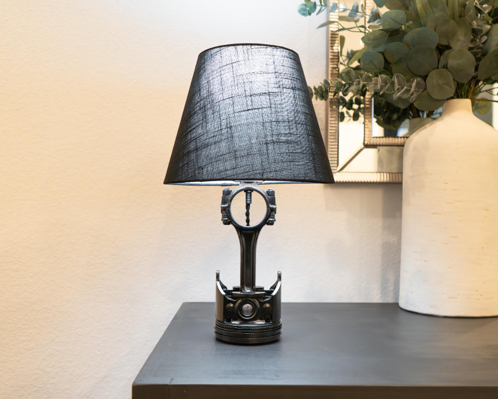 Home-friendly piston lamp crafted from real automotive parts, blending clean design with gentle car-inspired character.