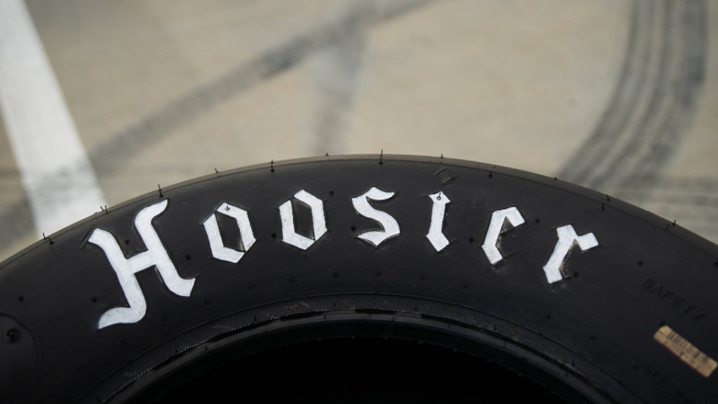 Hoosier tire coffee table featuring a flush plexiglass top that provides a smooth surface while preserving the racing tire look.