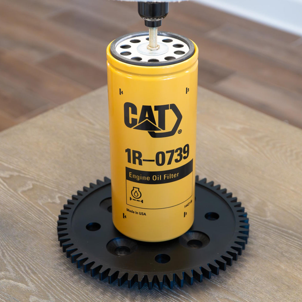 Industrial CAT equipment lamp featuring a black gear base inspired by real Caterpillar machinery.