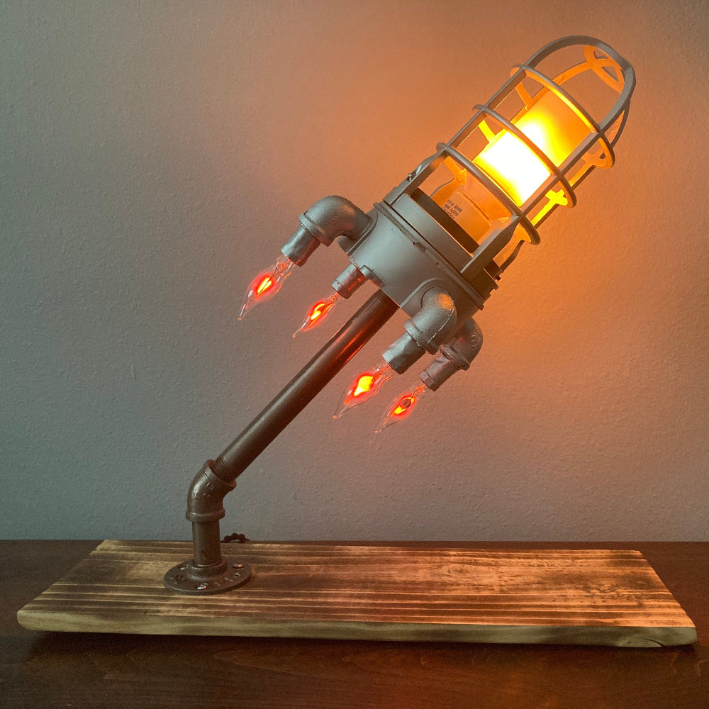 Rocket themed lamp designed for kids bedrooms playrooms or space inspired decor setups.