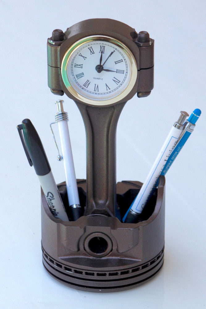 Mechanic desk piston clock that combines real engine parts with practical time display and storage space.