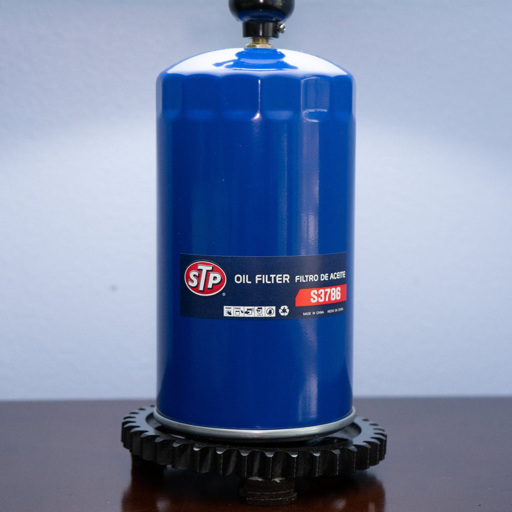 Mechanic style oil filter lamp repurposed from real car parts into functional decor.