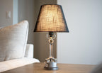 Minimal piston lamp paired with a matte black lampshade, creating a sleek and balanced tabletop lighting piece.
