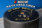 Racing tire table handcrafted from a retired NASCAR tire, designed as durable automotive decor for garages and man caves.