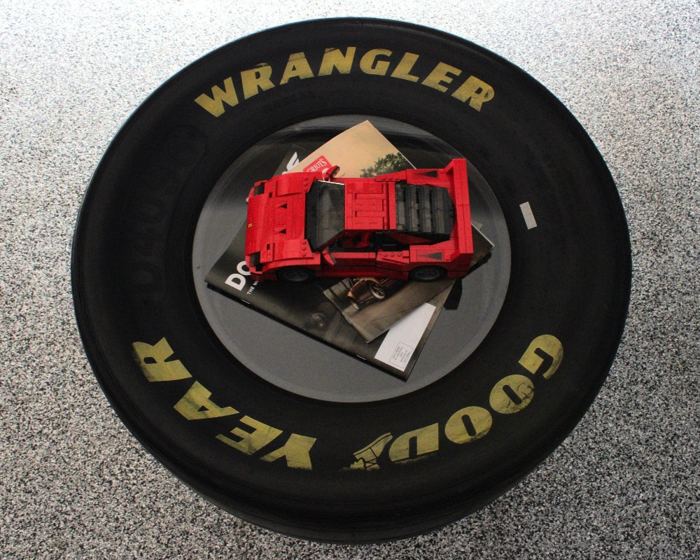 NASCAR tire table with plexiglass shelves providing a smooth tabletop surface and durable interior storage design.