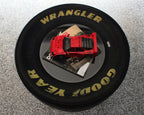 NASCAR tire table with plexiglass shelves providing a smooth tabletop surface and durable interior storage design.