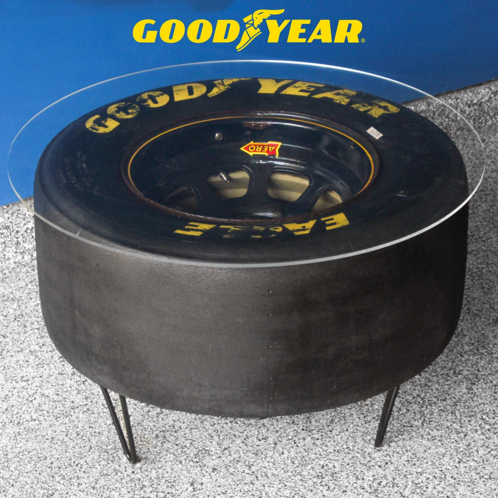 NASCAR tire table with wheel made from a retired racing tire, sealed with a clear coat and built as bold automotive furniture.