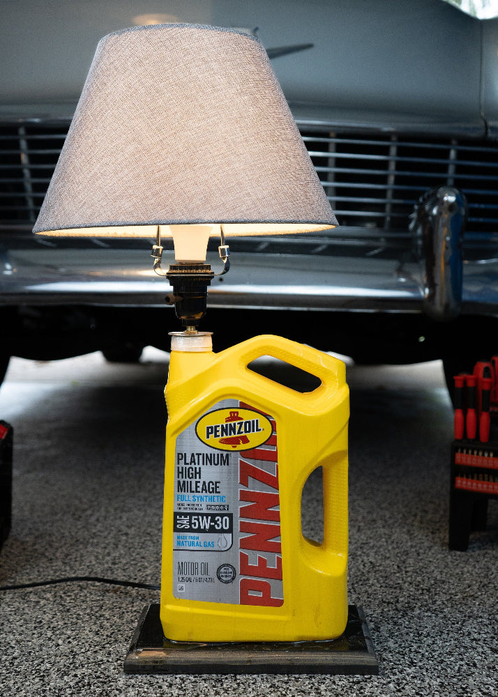 Close up detail of Pennzoil lamp showing epoxy finish and wood base texture.