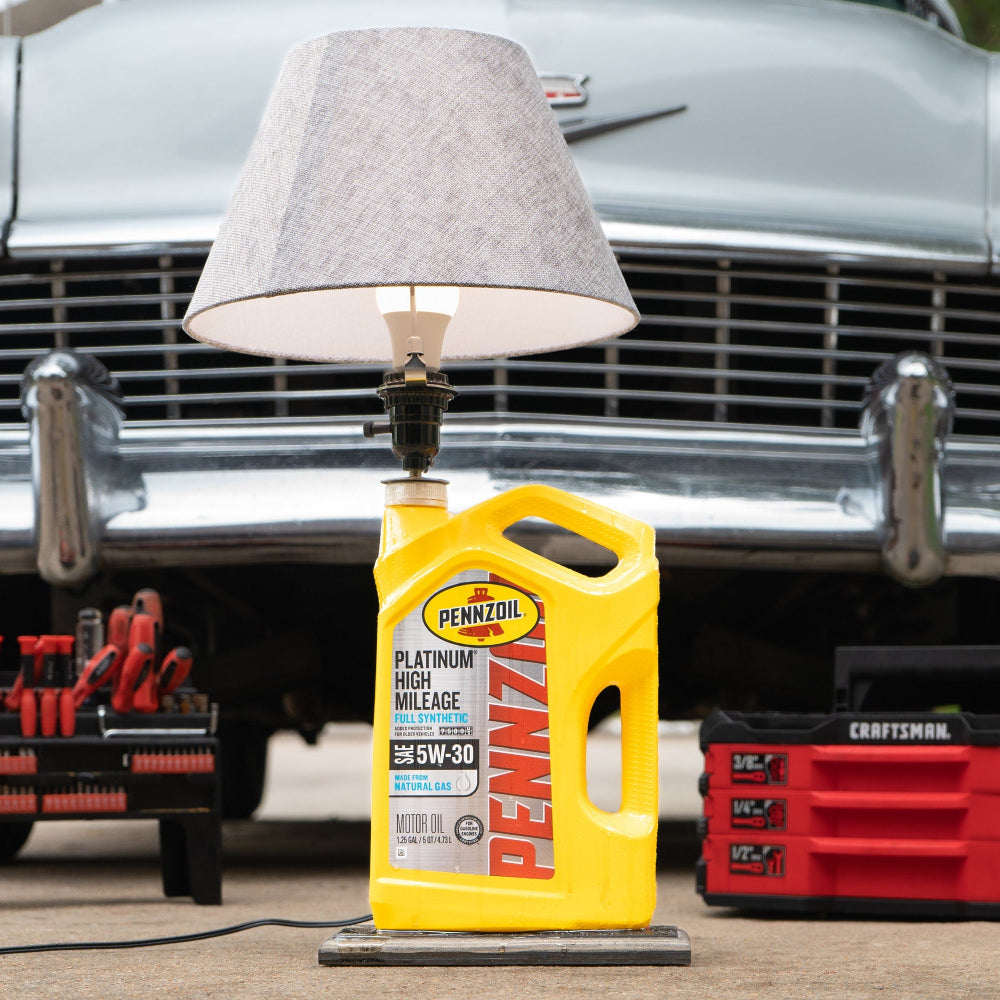 Pennzoil lamp made from real oil jug mounted on oak base with glossy epoxy drip design.