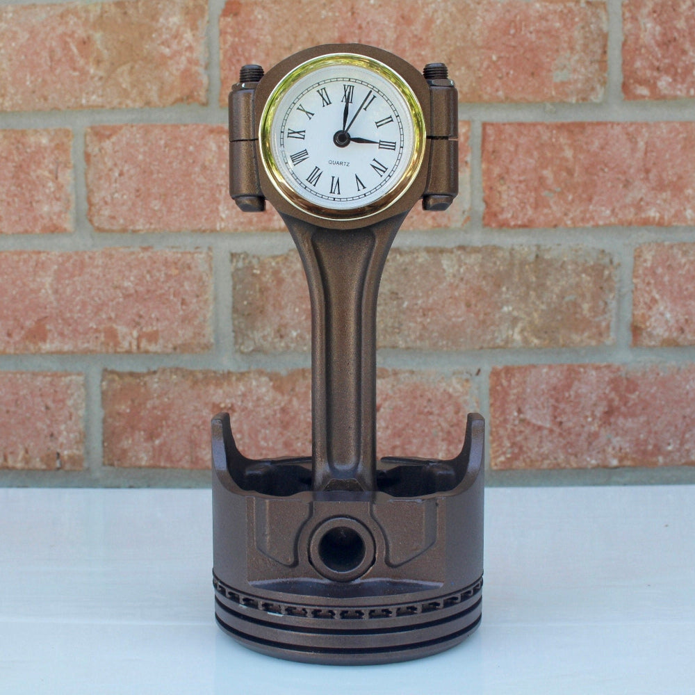 Close up view of piston clock showing quartz time display and authentic engine surface texture.