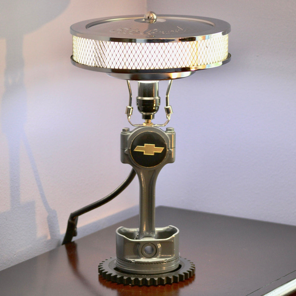Piston lamp featuring a Ford logo centerpiece, made from real car parts and designed as bold automotive home decor.