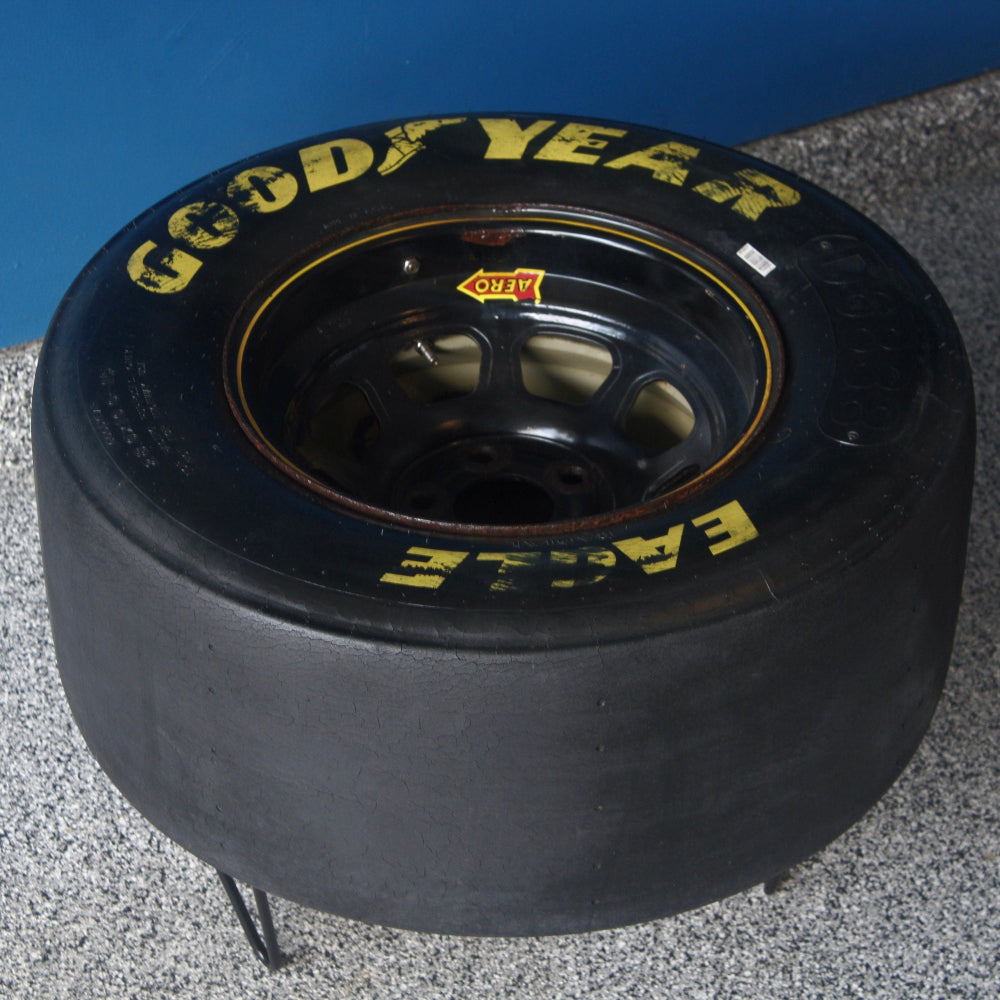 Race car tire table designed as statement home decor, made from a real retired tire with authentic racing appeal.