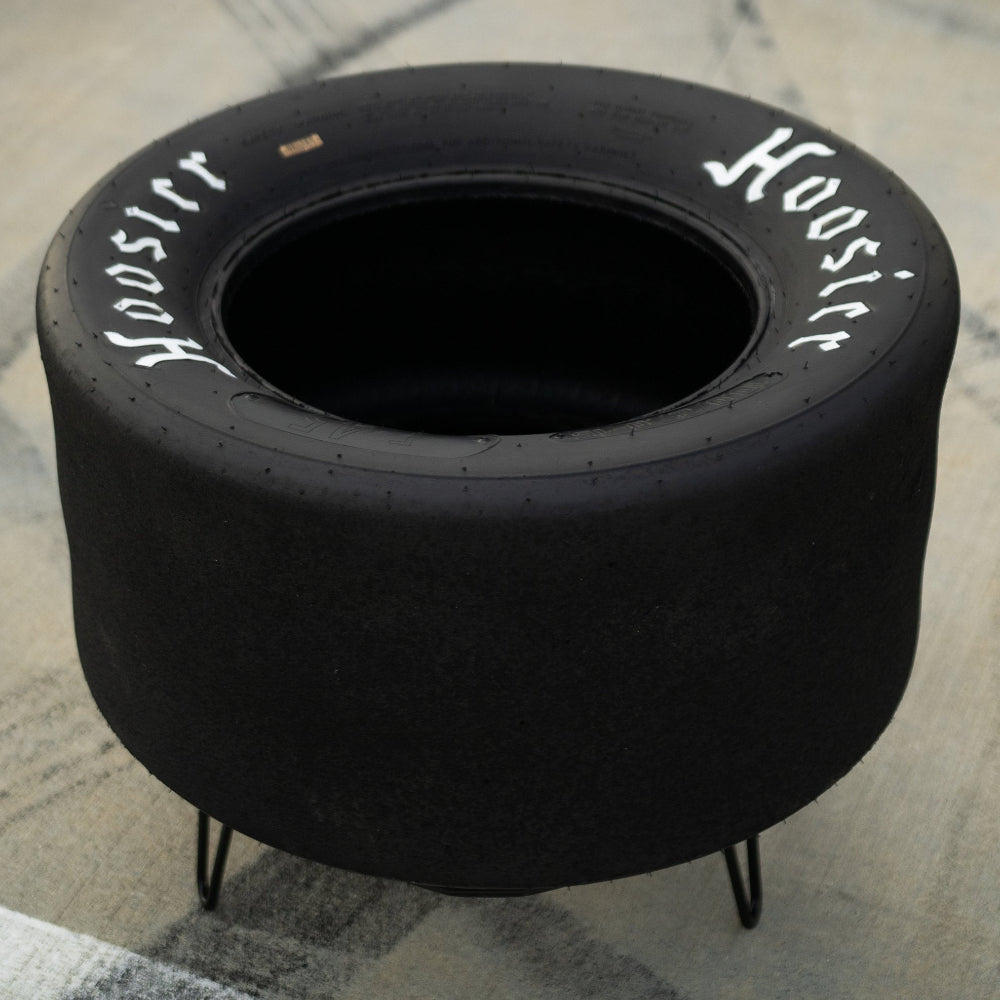 Racing tire table used as home decor, crafted from an authentic Hoosier tire for motorsports-inspired interiors.