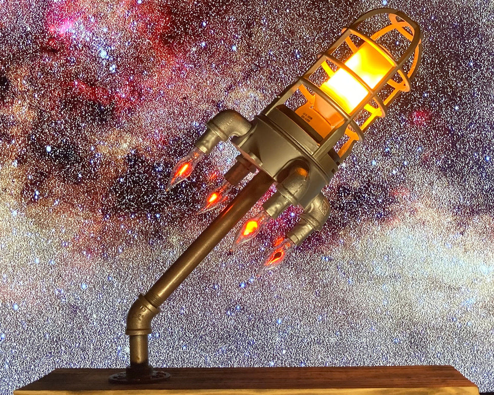 Rocket lamp featuring LED flame effect lighting that creates a realistic glowing launch style display.