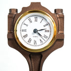 Sandblasted Ford piston clock revealing original stamp and mechanical detail.