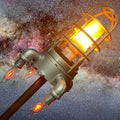 Space rocket lamp with LED flame lighting and shiny silver finish designed for kids rooms and space themed decor.