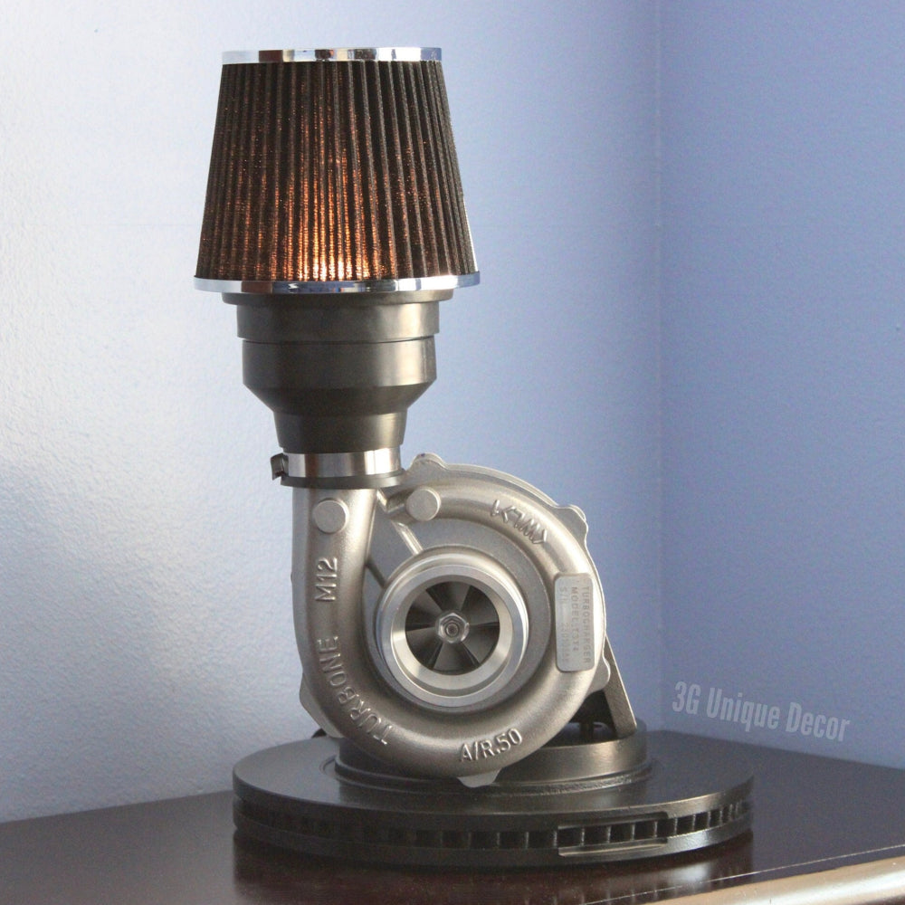 Turbocharger lamp made from real car parts, featuring a brake rotor base, new turbocharger, and air filter light for bold automotive decor.