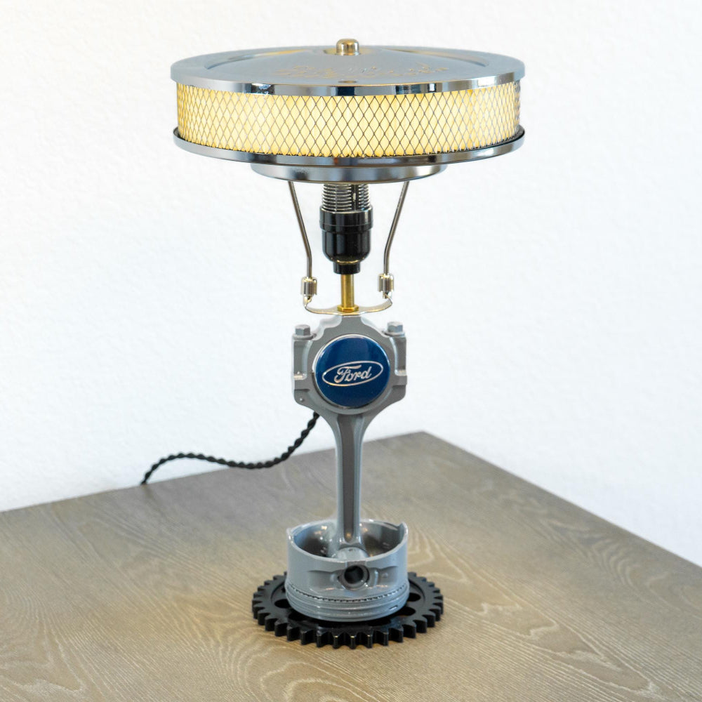 V8 Ford piston lamp built from authentic engine parts, combining mechanical character with functional interior lighting.